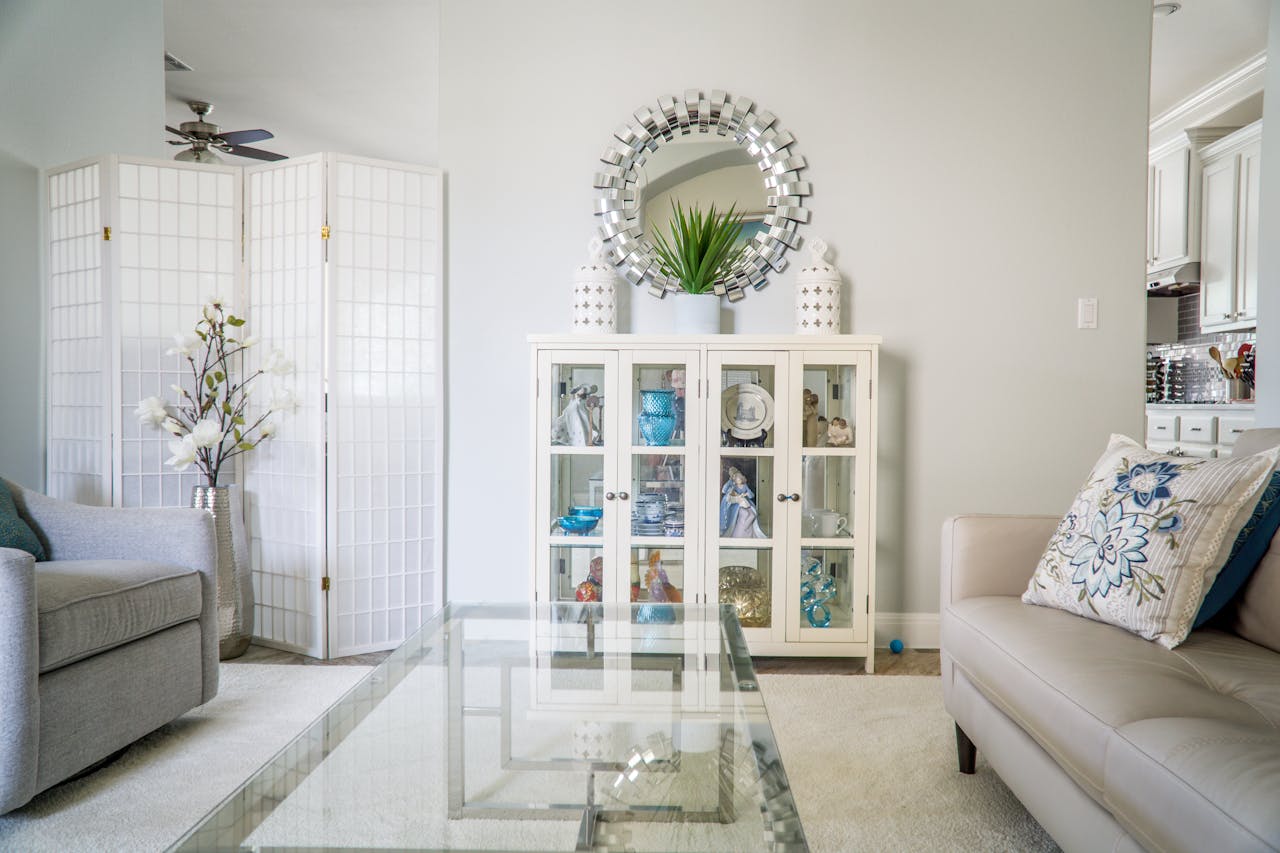 Bright living room with modern decor, featuring a glass table, plush sofas, and decorative elements in Austin, TX.